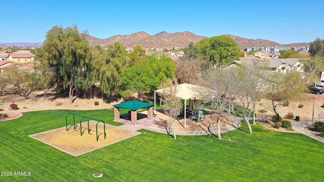 exterior space with a residential view, a mountain view, playground community, and a yard