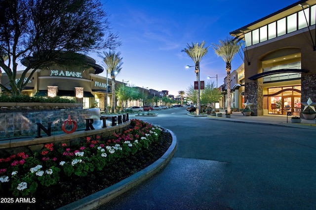 view of road with curbs, sidewalks, and street lighting