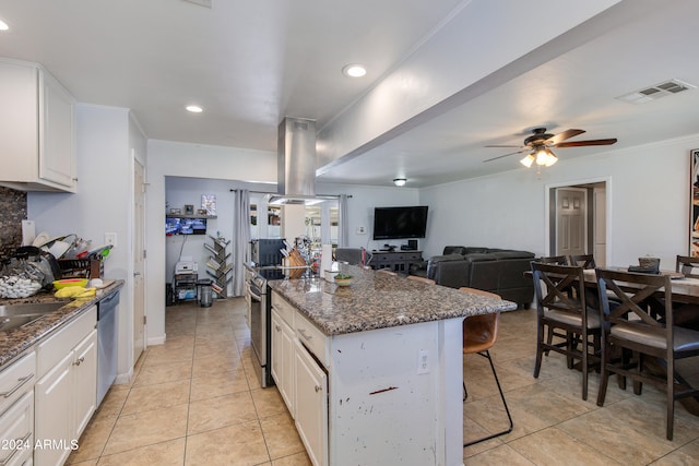 kitchen featuring island exhaust hood, white cabinets, and stainless steel appliances