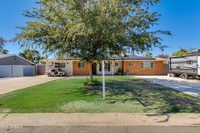 7830 N 17th Ave, Phoenix, AZ 85021 - ranch-style home with solar panels, driveway, and brick siding