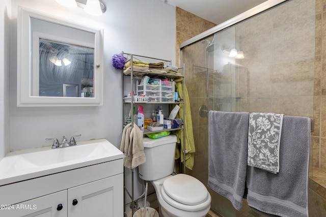 bathroom with vanity, toilet, and an enclosed shower