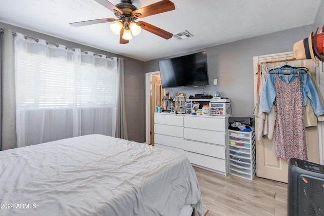 bedroom with light hardwood / wood-style flooring and ceiling fan