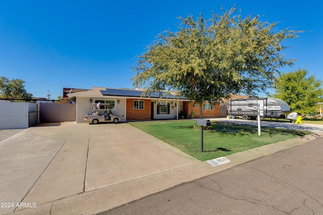 7830 N 17th Ave, Phoenix, AZ 85021 - single story home featuring solar panels, concrete driveway, and brick siding