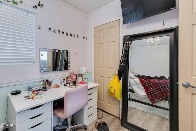 bathroom featuring vanity, hardwood / wood-style flooring, ornamental molding, and a chandelier