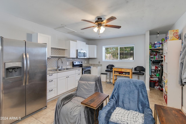 7830 N 17th Ave, Phoenix, AZ 85021 - kitchen with stainless steel appliances, a sink, light tile patterned flooring, white cabinetry, and backsplash