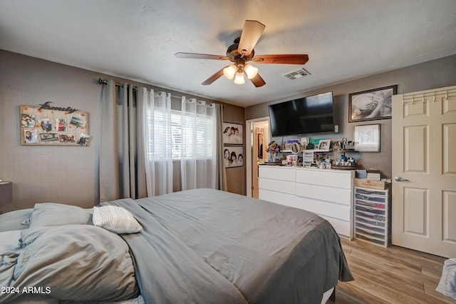 bedroom featuring light wood-type flooring and ceiling fan