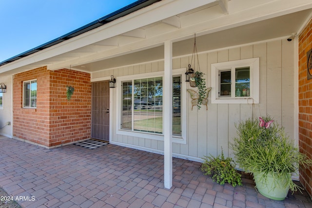 7830 N 17th Ave, Phoenix, AZ 85021 - property entrance featuring board and batten siding, brick siding, and covered porch