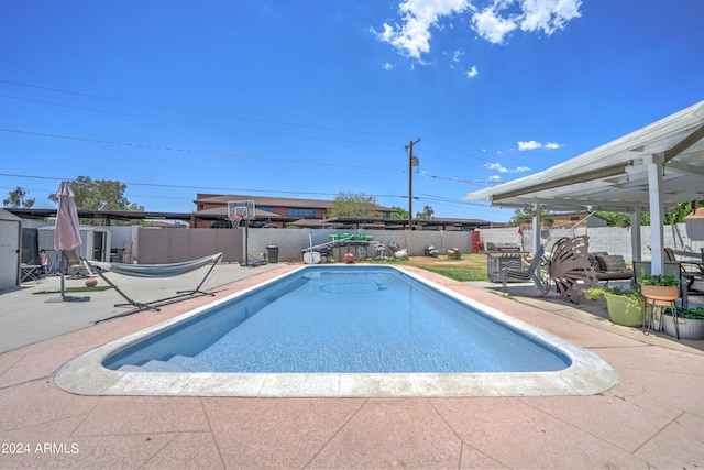 view of swimming pool with a patio area