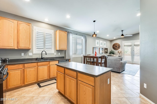 kitchen with a ceiling fan, a sink, black gas range, and dark countertops