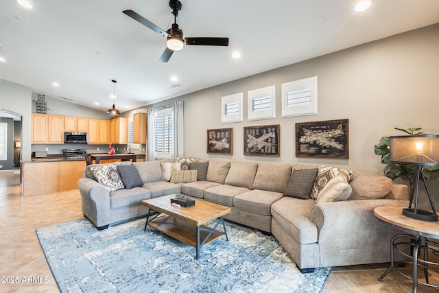living area with recessed lighting, a ceiling fan, light tile patterned flooring, and vaulted ceiling