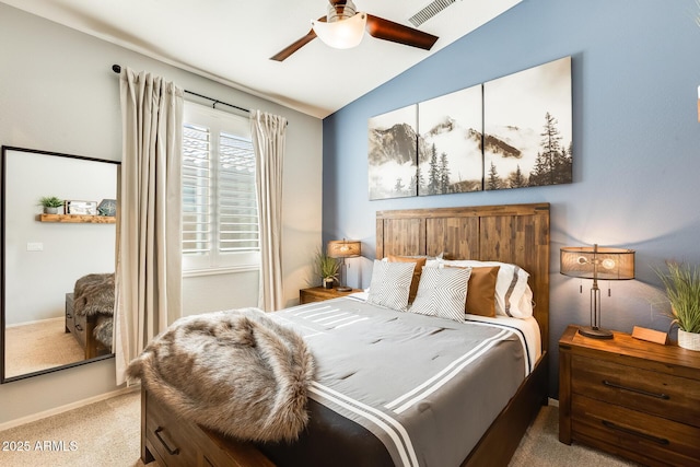 carpeted bedroom with visible vents, vaulted ceiling, and a ceiling fan