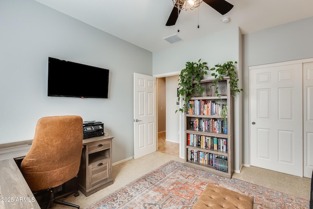 home office with carpet, visible vents, baseboards, and a ceiling fan