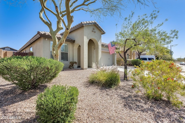 mediterranean / spanish-style home with stucco siding and a tile roof
