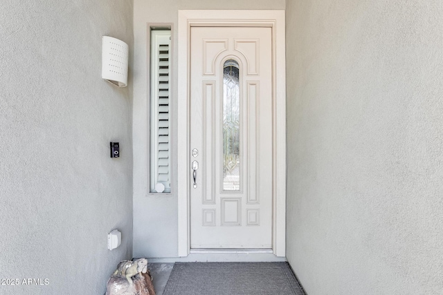 doorway to property with stucco siding