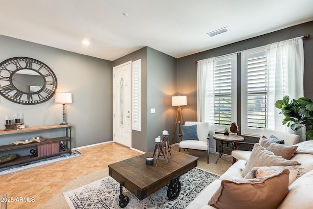 tiled living area with visible vents, baseboards, and recessed lighting