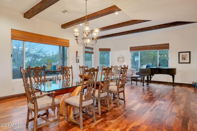 dining space featuring hardwood / wood-style flooring, plenty of natural light, a notable chandelier, and lofted ceiling with beams