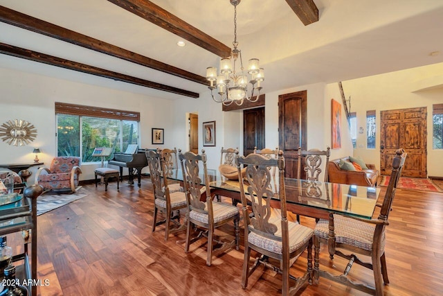 dining area with beam ceiling, a chandelier, and wood-type flooring