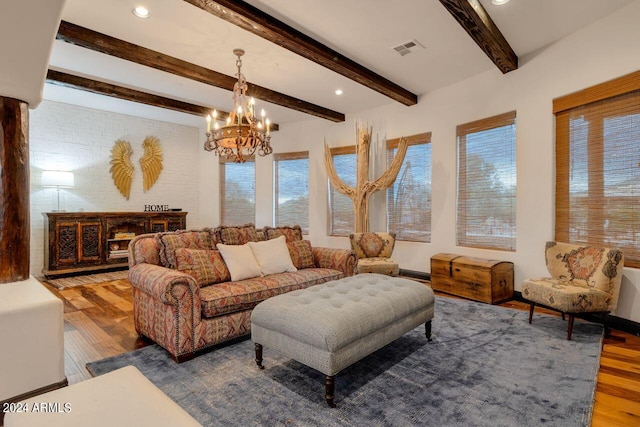 living room with wood-type flooring, a notable chandelier, and beam ceiling