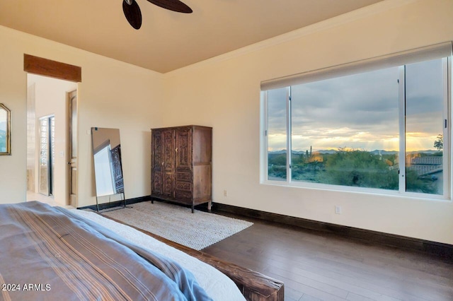 unfurnished bedroom featuring wood-type flooring, crown molding, and ceiling fan