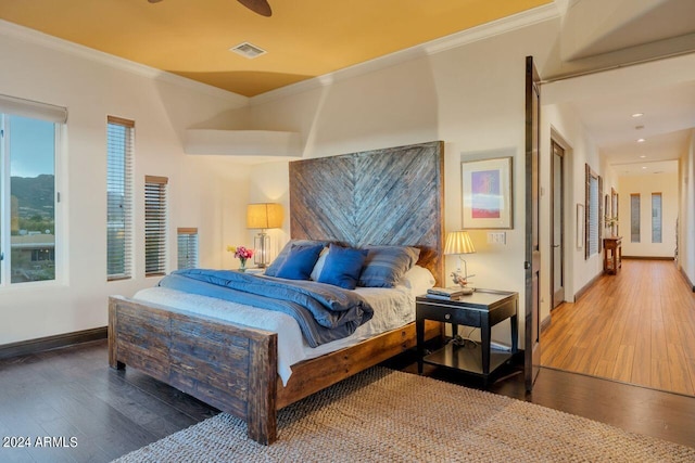 bedroom featuring ornamental molding, hardwood / wood-style flooring, and ceiling fan