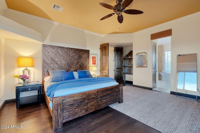 bedroom with ceiling fan, crown molding, dark hardwood / wood-style flooring, and ensuite bath