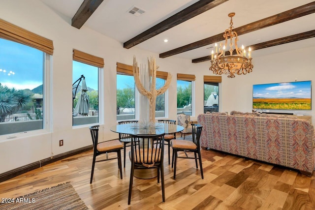 dining room with an inviting chandelier, beam ceiling, and light hardwood / wood-style flooring