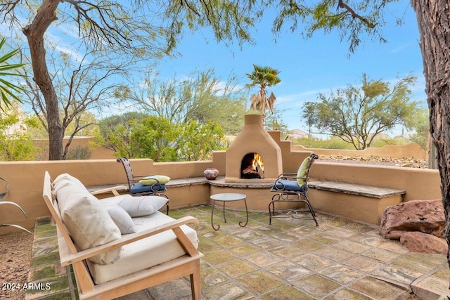 view of patio / terrace featuring an outdoor fireplace