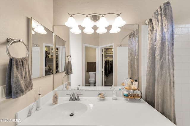 2221 E Union Hills Dr Unit 148, Phoenix, AZ 85024 - bathroom with a spacious closet, toilet, a tile shower, vanity, and a chandelier