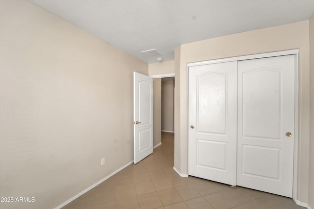 2221 E Union Hills Dr Unit 148, Phoenix, AZ 85024 - unfurnished bedroom with baseboards, a closet, and light tile patterned floors