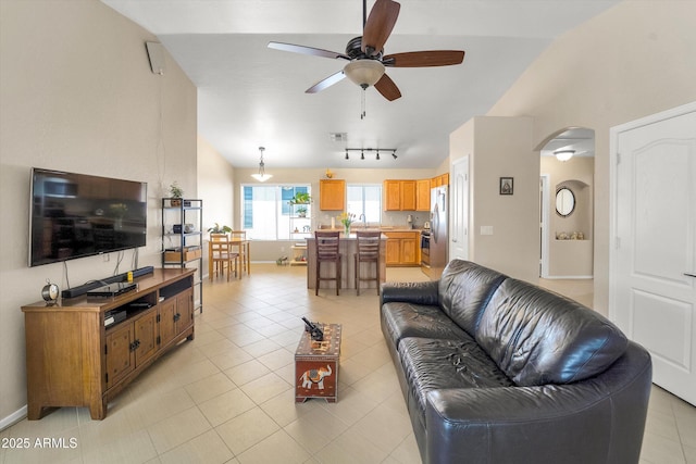 2221 E Union Hills Dr Unit 148, Phoenix, AZ 85024 - living room with a ceiling fan, arched walkways, light tile patterned flooring, and high vaulted ceiling