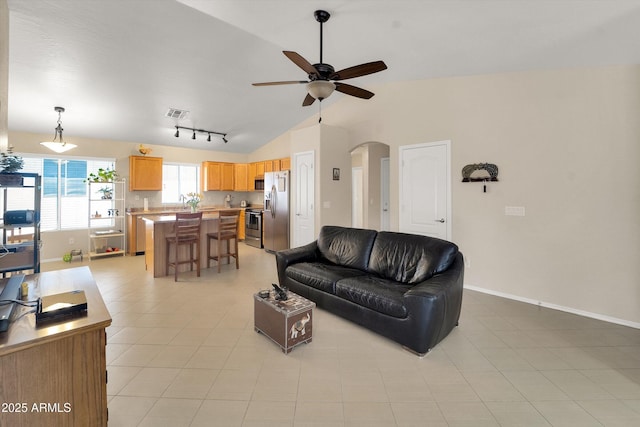 2221 E Union Hills Dr Unit 148, Phoenix, AZ 85024 - living room featuring lofted ceiling, ceiling fan, arched walkways, baseboards, and rail lighting