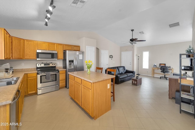 2221 E Union Hills Dr Unit 148, Phoenix, AZ 85024 - kitchen with stainless steel appliances, open floor plan, vaulted ceiling, a ceiling fan, and rail lighting