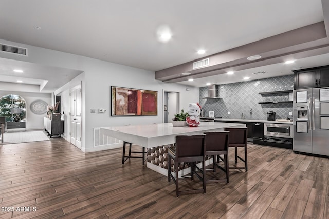 dining room with dark wood-type flooring, recessed lighting, and visible vents