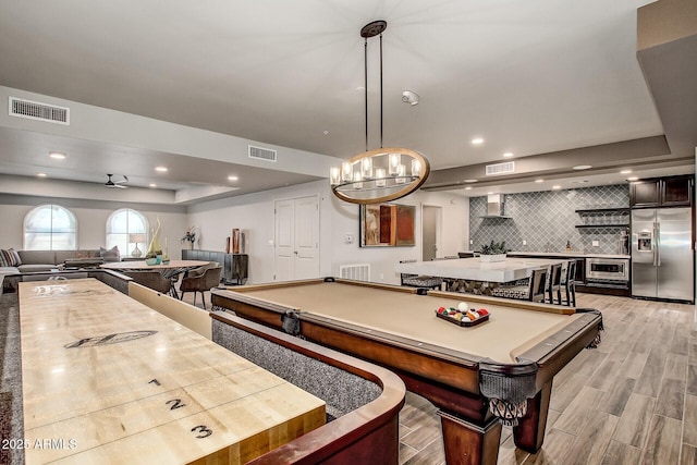 game room with a tray ceiling, billiards, visible vents, and light wood-style floors