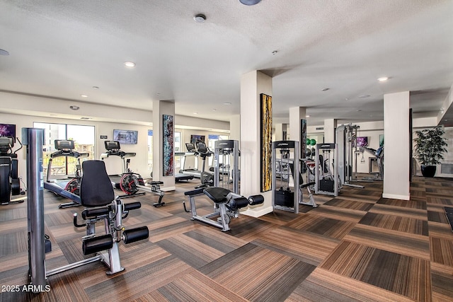 gym with a textured ceiling, recessed lighting, carpet flooring, and baseboards