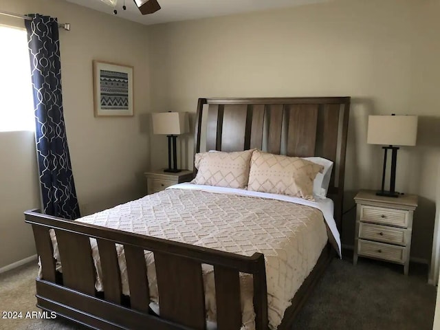 bedroom with ceiling fan and dark carpet