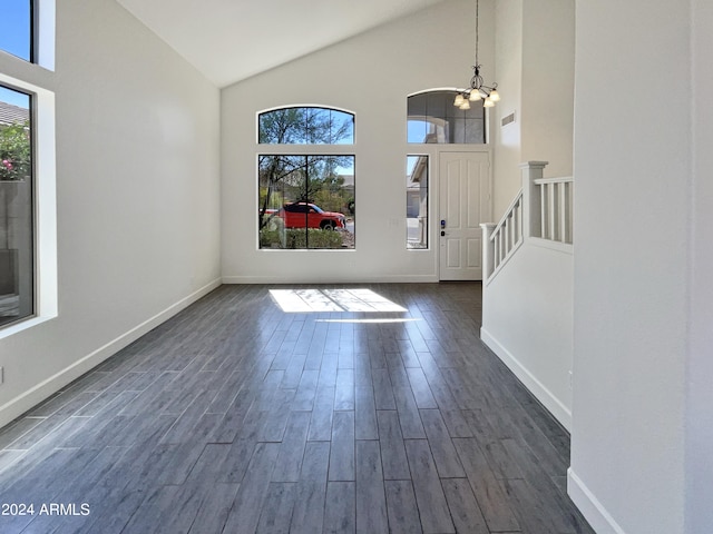 entrance foyer featuring a notable chandelier, dark hardwood / wood-style floors, and plenty of natural light