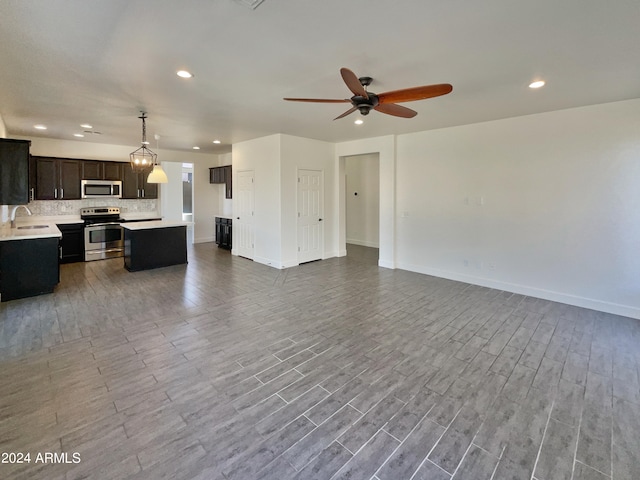 interior space with light hardwood / wood-style flooring, ceiling fan, appliances with stainless steel finishes, and decorative light fixtures