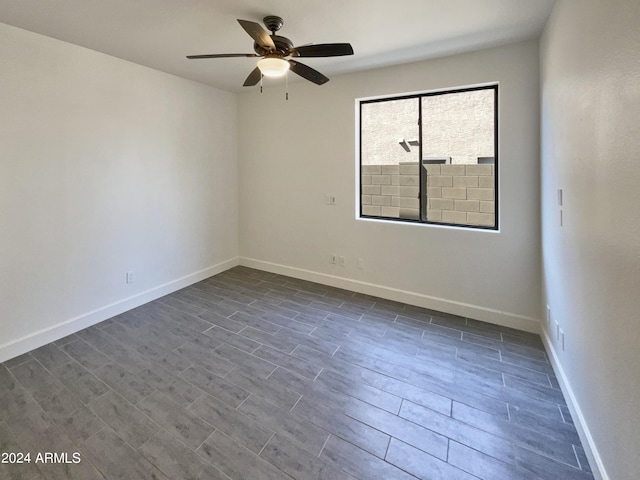 spare room featuring ceiling fan and dark hardwood / wood-style floors