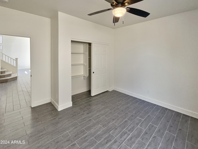 unfurnished bedroom with dark hardwood / wood-style flooring, ceiling fan, and a closet