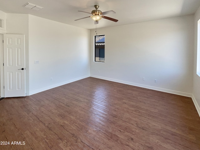 unfurnished room with ceiling fan and dark wood-type flooring