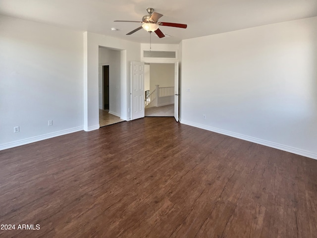 empty room featuring ceiling fan and dark hardwood / wood-style flooring