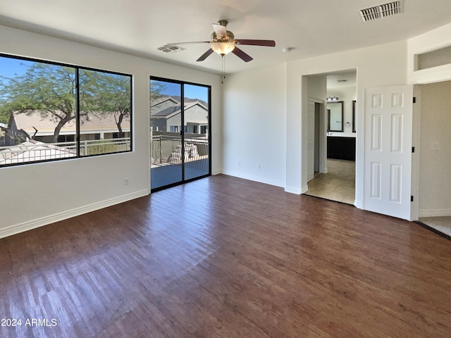 spare room featuring ceiling fan and dark hardwood / wood-style floors