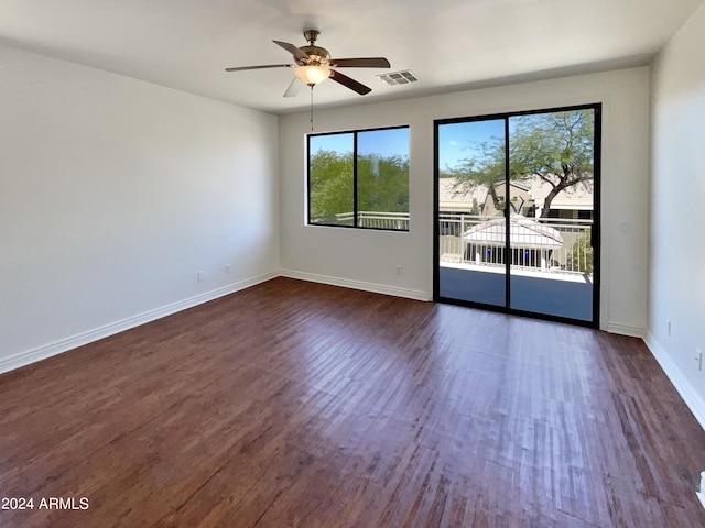 empty room featuring ceiling fan and dark hardwood / wood-style flooring