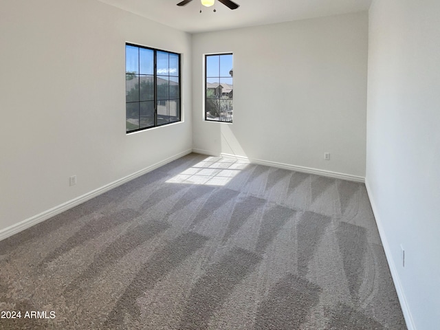 carpeted empty room featuring ceiling fan