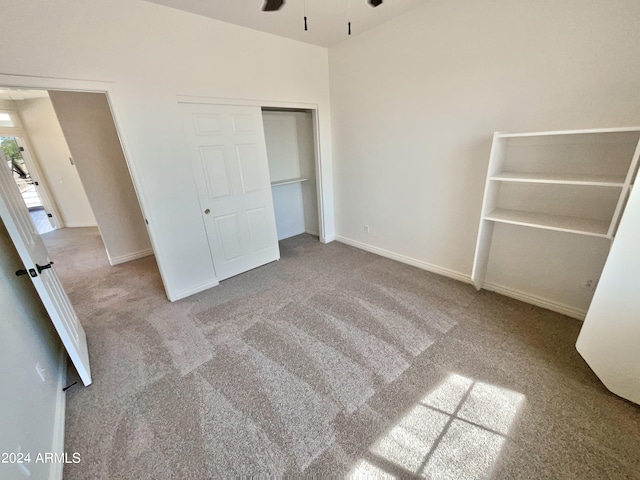 unfurnished bedroom with light carpet and a closet