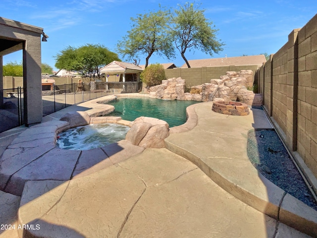 view of swimming pool with an in ground hot tub and a patio area