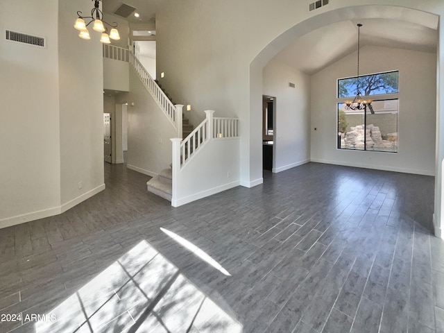 interior space with dark hardwood / wood-style floors, a chandelier, and high vaulted ceiling