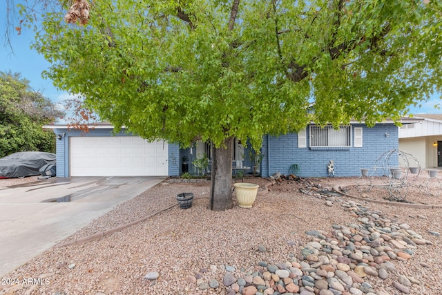 view of property hidden behind natural elements featuring a garage