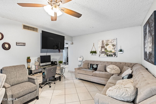 living room with a textured ceiling, light tile patterned floors, and ceiling fan